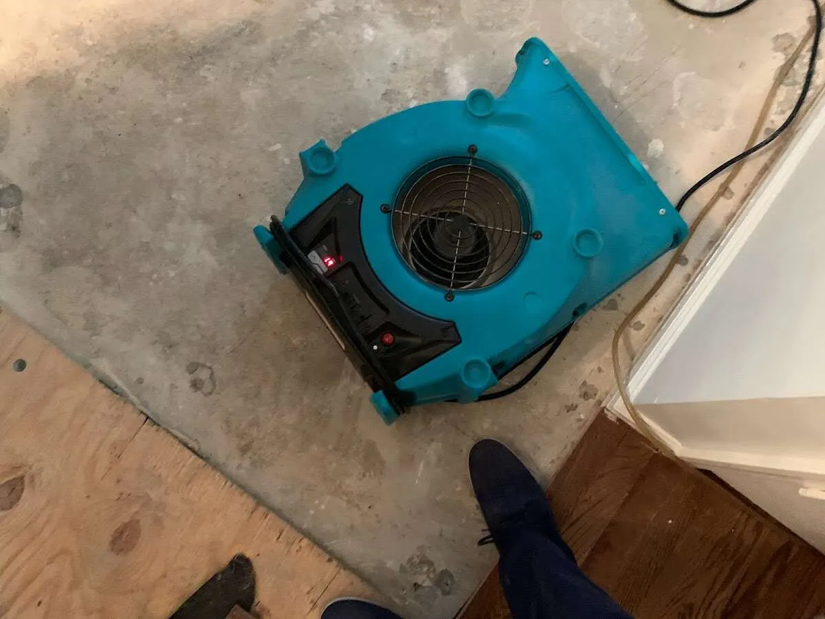 Air mover drying subfloor during Commercial Water Damage Restoration in Ellsworth